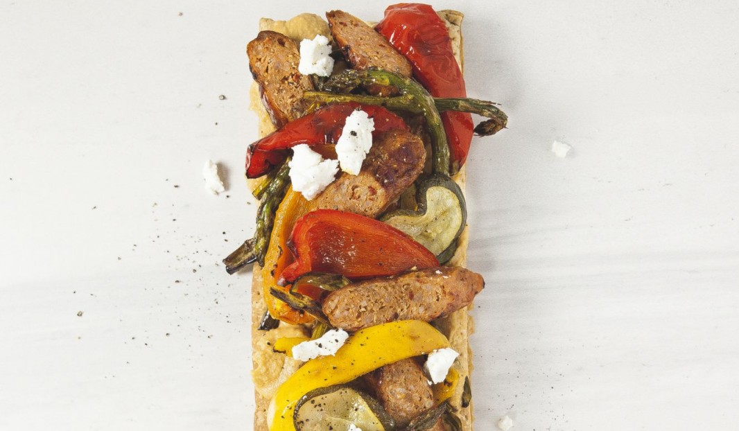 Puff pastry tart with hummus, vegetables, Italian sausage and  fresh goat cheese