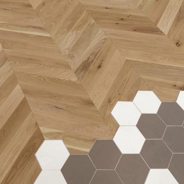 Floor with chevron pattern mixed with colored tiles